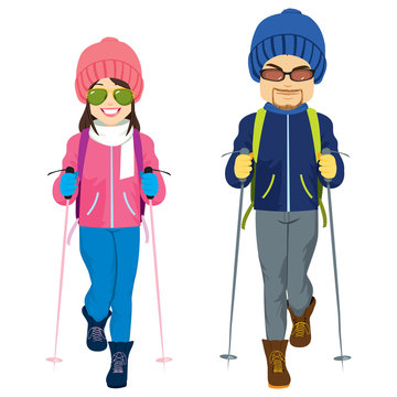 Young couple wearing ski winter clothes standing on white background