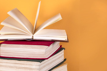 Open book, hardback bookson bright colorful background.