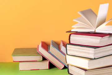 Open book, hardback bookson bright colorful background.