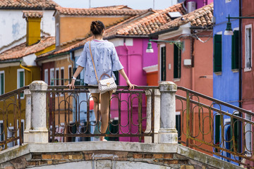 A tourist girl on the bridge on Burano Island Venice