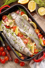Fototapeta na wymiar Raw trout with vegetables in a pan ready to bake