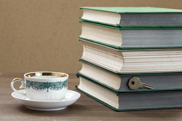 book firm cover  with a cup on a wooden table.