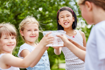 Drei Mädchen stoßen mit Wasser an