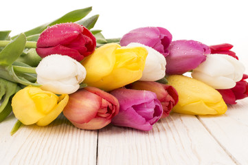 bouquet of tulips on rustic wooden board, easter decoration