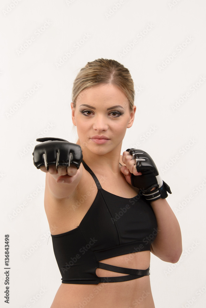 Wall mural young beautiful blonde sexy boxing girl posing with gloves on wh