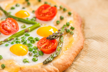 Spring pizza with vegetables and eggs