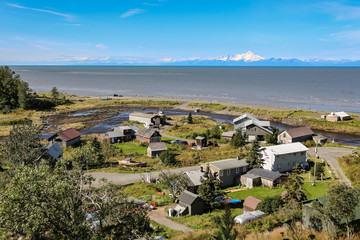 Aerial view of Ninilchik a small Alaskan Native village with Cook Inlet and Aleutian volcanoes in...