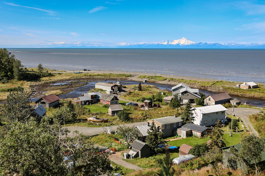 Aerial view of Ninilchik a small Alaskan Native village with Cook Inlet and Aleutian volcanoes in the background, Kenai Peninsula, Alaska