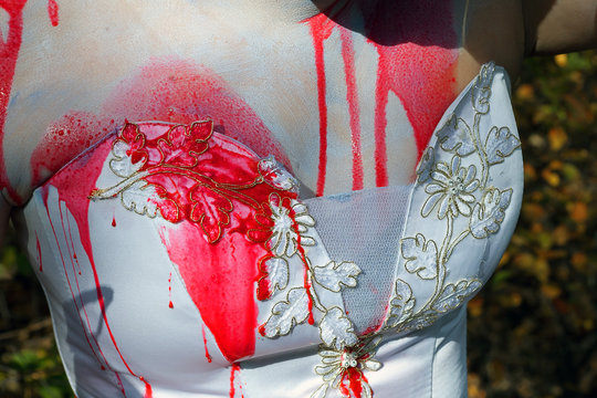 chest bride in white dress drenched with blood