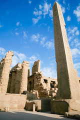 big obelisk of Queen Hatshetsut with carving figures and hieroglyphs in landmark Egyptian Karnak...