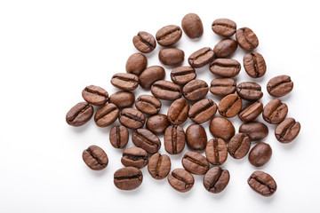 roasted coffee beans isolated in white background. Roasted coffee beans background close up. Coffee beans pile from top on white background with copy space for text. Good morning.