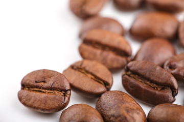 roasted coffee beans isolated in white background. Roasted coffee beans background close up. Coffee beans pile from top on white background with copy space for text. Good morning.