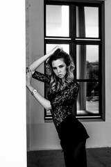 Gorgeous model girl in a lace body, posing outdoors. Black and white fashion photo