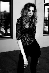 Gorgeous model girl in a lace body, posing outdoors. Black and white fashion photo