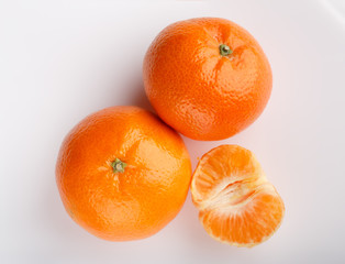 Ripe mandarin close-up on a white background. Tangerine orange. Colorful Food and drink still life concept. Fresh fruits and vegetables on color background. Clementine. Citrus. Fresh fruits. Diet.