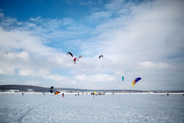 snow kiting on a snowboard on a frozen lake