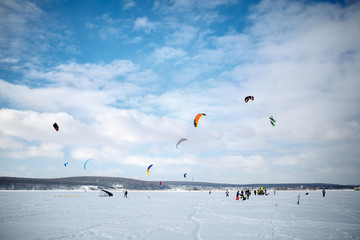 snow kiting on a snowboard on a frozen lake