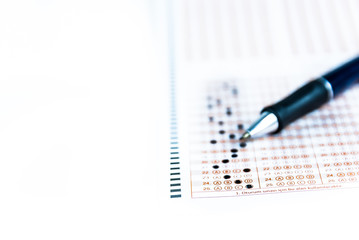 pencil and test paper on isolated white background