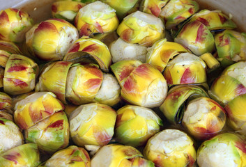 clean bottoms of artichokes prepared by the cook in the water