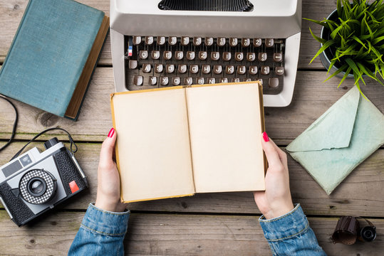 Woman holding old notebook with copyspace