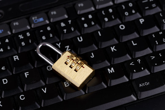 golden lock on black keyboard - computer security concept