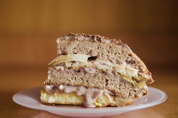 Homemade chocolate blackout cake with a cut piece on a wooden table, square.