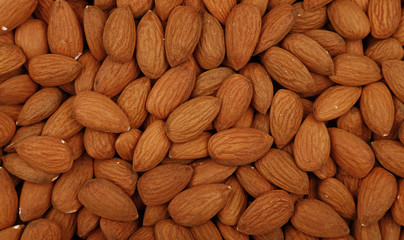 Raw whole almond nuts close up top view
