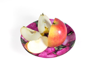 Cut into slices of ripe, juicy apple in a plate on a white background. Vitamin diet for weight loss.