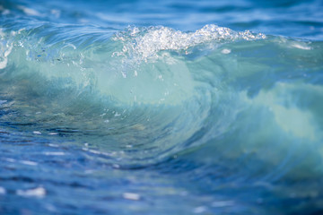 Blue wave on shore. Clear water in ocean