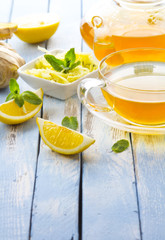 tea ginger lemon mint vintage wood background
