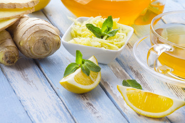 tea ginger lemon mint vintage wood background
