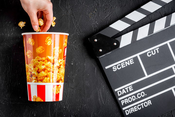concept of watching movies with popcorn top view dark background