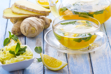 tea ginger lemon mint vintage wood background
