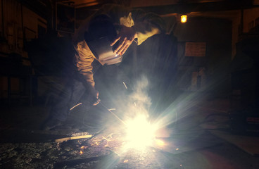 Cooks working of metal products in the welding mask