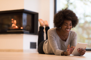 black women used tablet computer on the floor