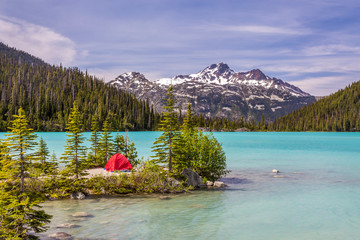This red tent offer a nice contrast with the turquoise water of Upper Joffre Lake in British...