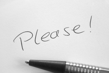 Handwritten word Please on white paper