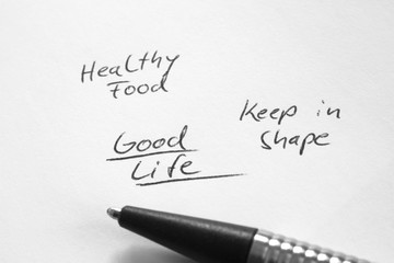 Good life, healthy food, keep in shape, handwritten phrase on white paper