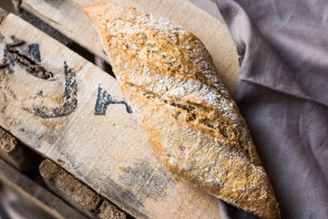 Rye whole wheat bread roll with golden crust dusted with flour o