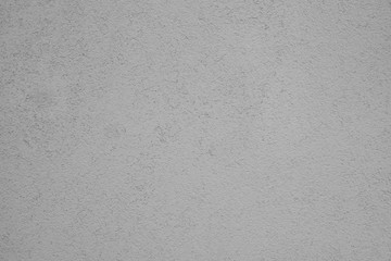 Detail of the facade of the house, wall plastered and painted in gray, background