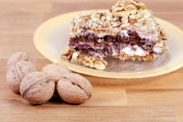 portion of white and brown chocolate walnut cake with walnuts
