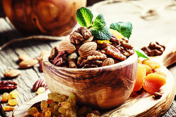 Healthy snack: raw nuts and dried fruit, decorated with mint. Vi