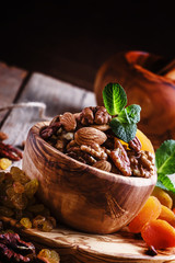 Healthy snack: raw nuts and dried fruit, decorated with mint. Vi