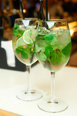 Two mojito cocktails on the bar in the restaurant