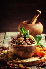 Healthy snack: raw nuts and dried fruit, decorated with mint. Vi