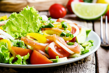 Salad with salted salmon and vegetables. Vintage wood background