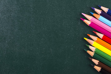 colorful pencils on blackboard