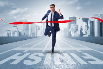 Businessman on the finishing line in competition concept