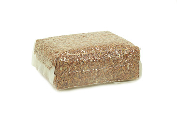 Brown rice in vacuum plastic bag isolated on white background
