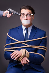 Businessman taken hostage and tied up with rope